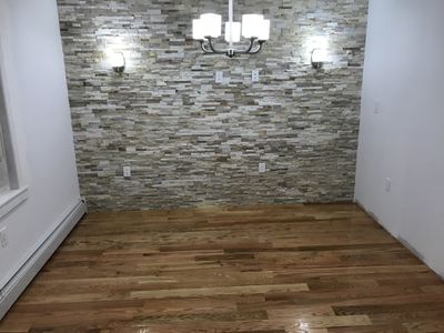 Dining room - hardwood floor, decorative stone wall & paint